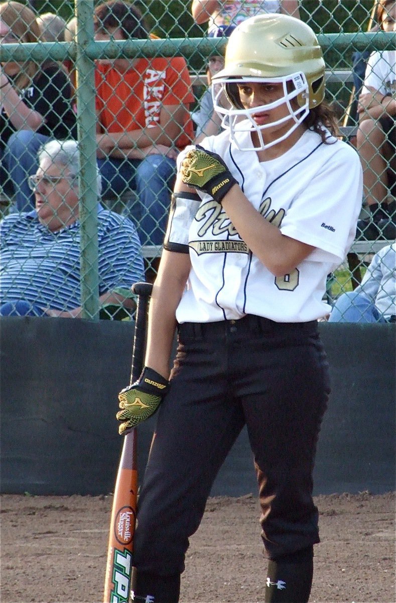 Image: Up her sleeve — Anna Viers takes the “hit a homerun sign” from coach Jennifer Reeves.