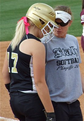 Image: Here’s the plan — Lady Gladiator Coach Jennifer Reeves talks shop with Megan Richards before her at bat.