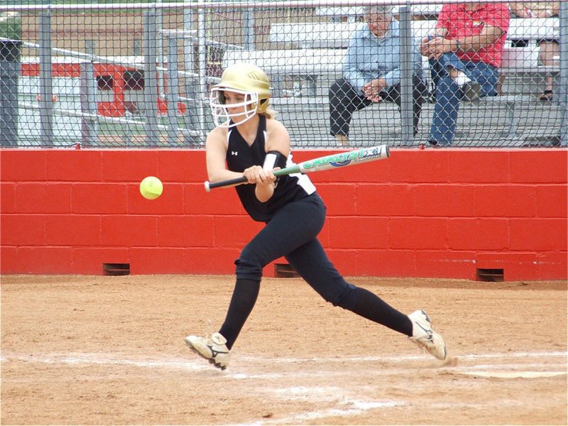 Image: One giant step — Courtney Westbrook tries to lead off with a hit to help lead her Lady Gladiator teammates one step closer to a state title.