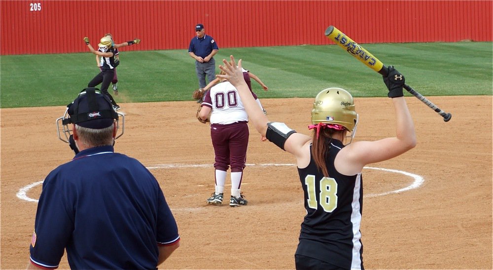 Image: Teamwork — Stay! Bailey Bumpus yells to teammate Anna Viers to stay on the bag after Viers stole second base.