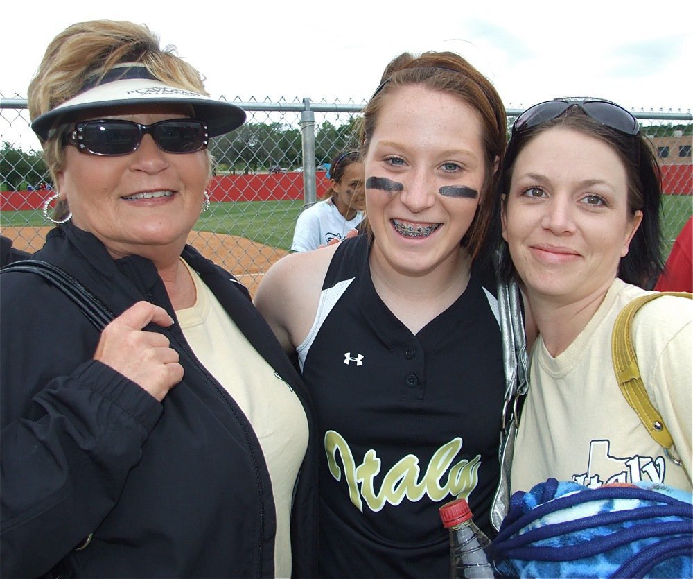 Image: Our hero! — Bailey Bumpus gets hugged by family members after making the game winning catch in center field to preserve the bi-district championship for the Lady Gladiators.