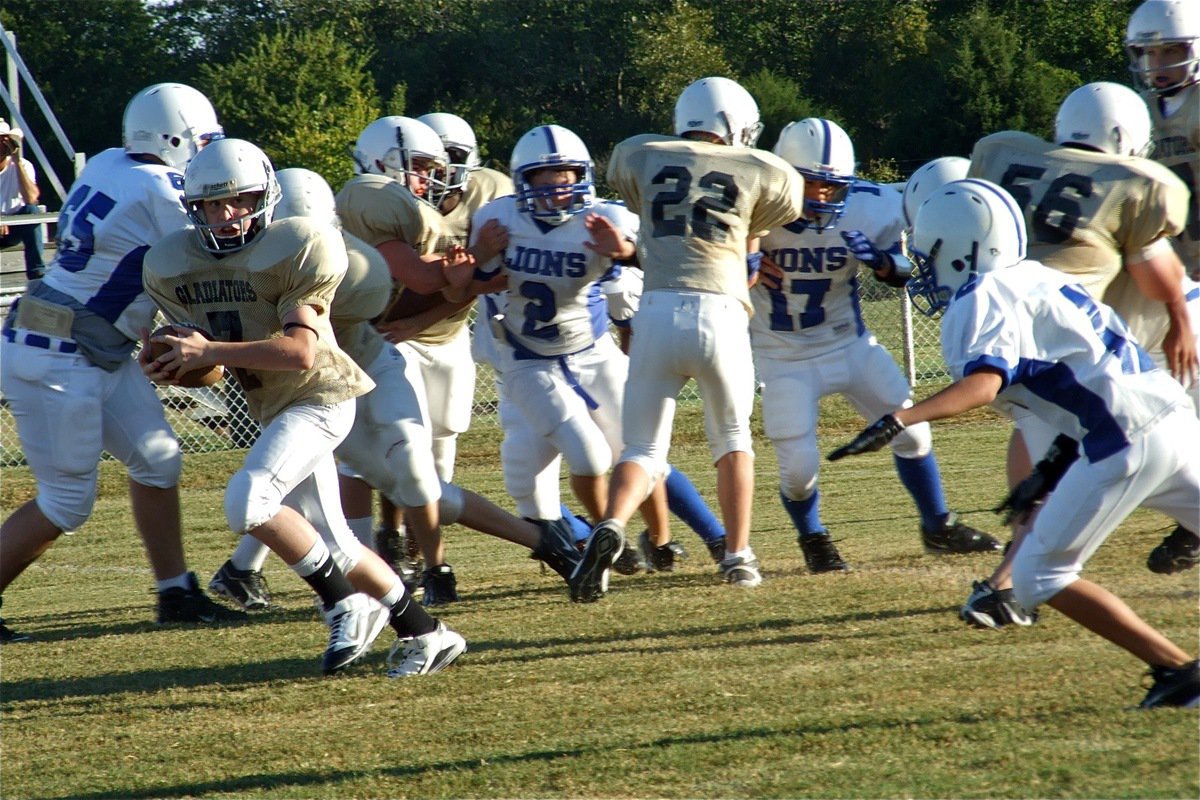 Image: In the clear — Italy’s John Escamilla(7) rushes for a first down thru the middle of the Lions’ defense.