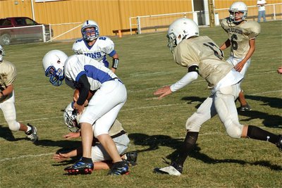 Image: Grass flying tackle — Caden Petrey and Ryan Connor(17) force the Lions’ Quarterback out of bounds.