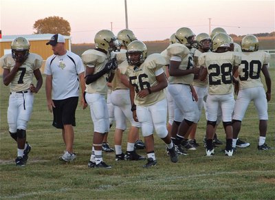 Image: Richters talks football — Coach Richters talks with the JV Gladiators’ defensive unit during a timeout.