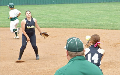 Image: Cori to Drew — Second baseman Cori Jeffords throws to Drew Windham at first base for the out.