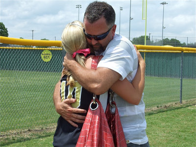 Image: Loving embrace — Senior Courtney Westbrook is embraced by her father Kelly Westbrook after the game.