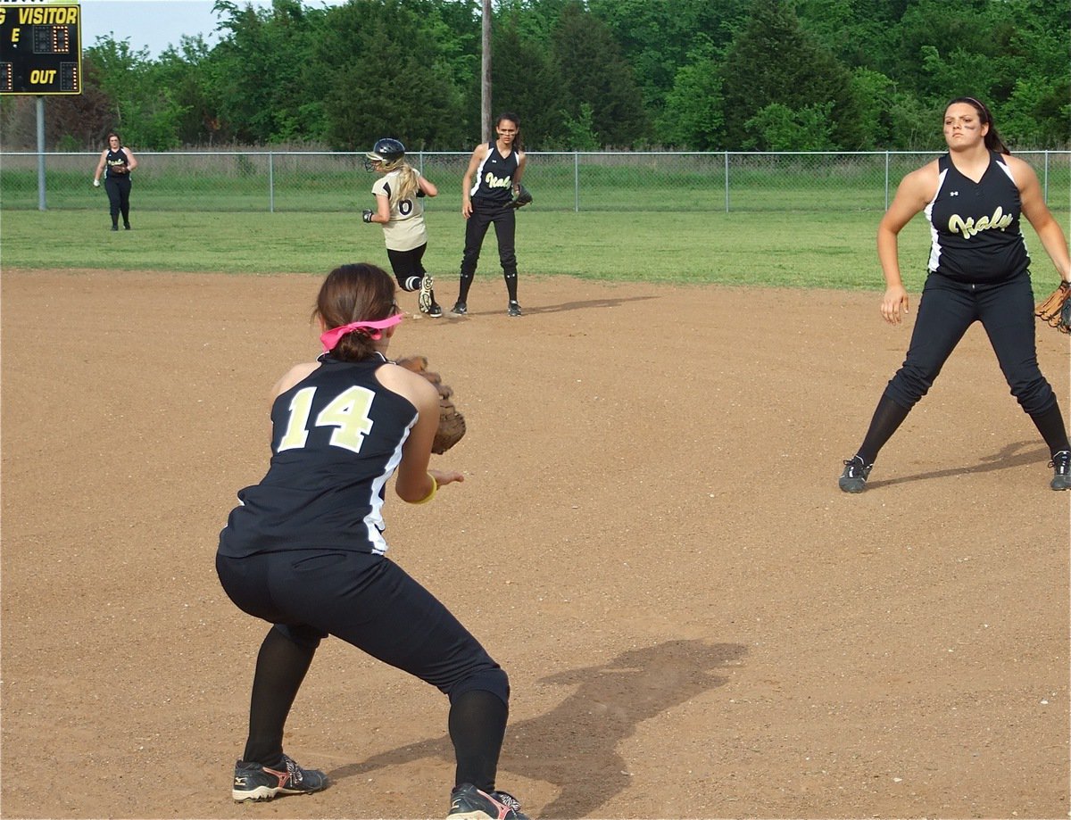 Image: One out — Second baseman Cori Jeffords flips the ball to first baseman Drew Windham for an out.