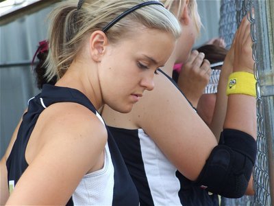 Image: Obstacles — Lady Gladiator pitcher Courtney Westbrook takes a quick glance down at her injured pitching hand. Westbrook managed to stay in the game and get the win over Dawson.
