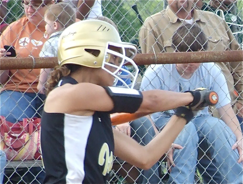 Image: Viers peers — Anna Viers keeps her eyes open and on the ball to start off the game with a single.