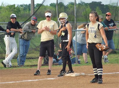 Image: Breathe and Listen — Alma Suaste catches her breath after racing to third base as coach Jennifer Reeves gives her instructions.