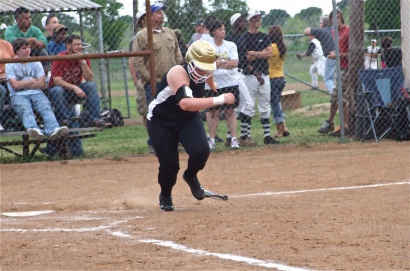 Image: ‘Brum’ drums it — Meredith Brummet heads toward first base after making contact.