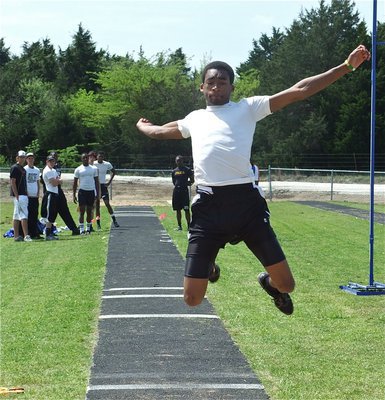 Image: Heath has hops — Heath Clemons leaps to third place in the triple jump.
