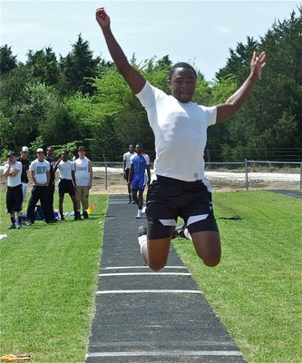 Image: Senio soars — Jasenio Anderson grabs air in the triple jump event.