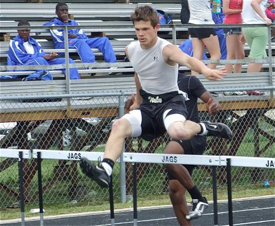 Image: Chase hurdles — Chase Hamilton takes 5th place in the 300m hurdles.