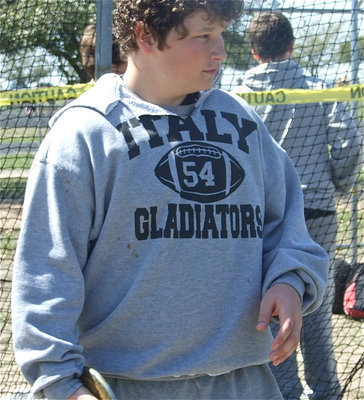 Image: John takes a look — 7th grader John Byers eyes the lead mark as he approaches the discus platform.