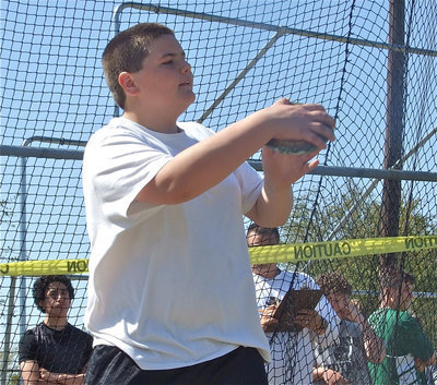 Image: Caution: Bales At Work — 7th grader Kelton Bales rips off his IJH track sweater and gets to work on the discus slab.