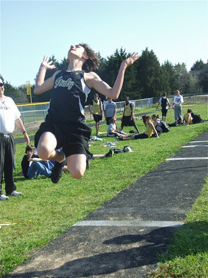Image: Witte measures up — 7th grader Jacob Witte gets all the distance he can out of this long jump.