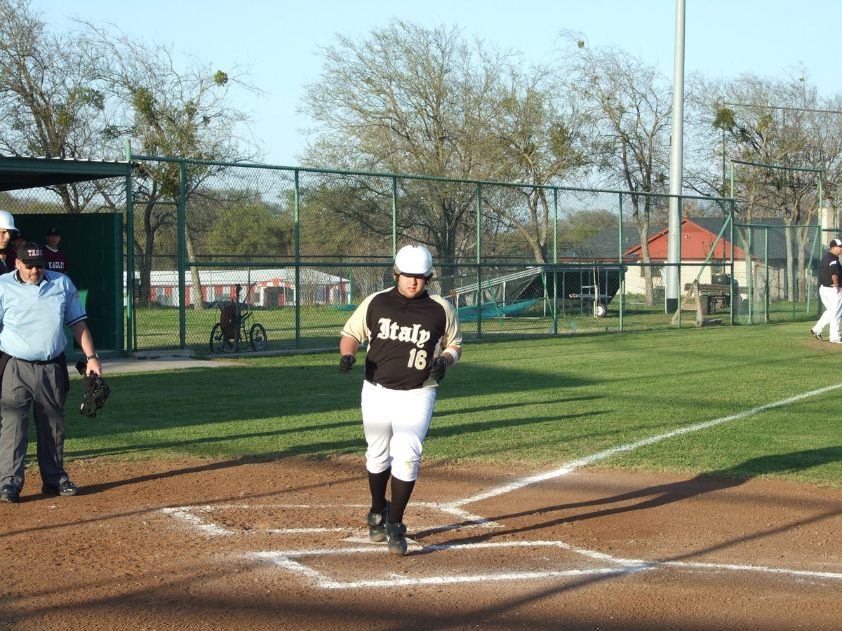 Image: Ivan scores — Senior Ivan Roldan comes across home plate to score.