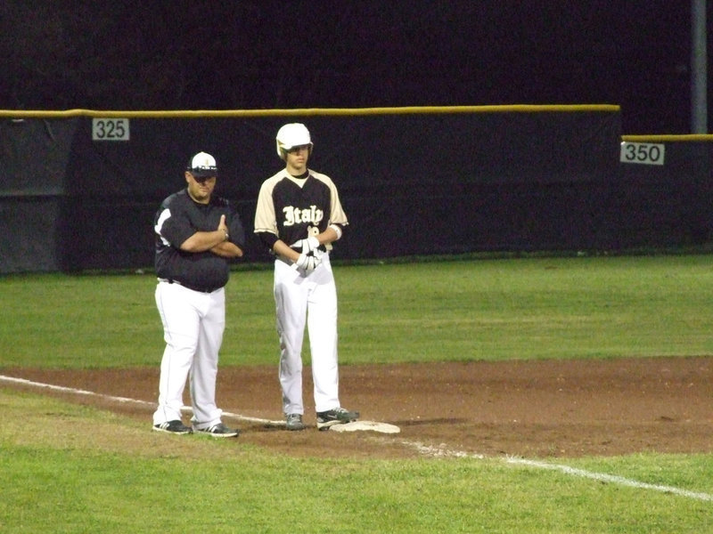 Image: A small wait — Cole Hopkins hangs out at third base with Coach Coker until it’s time to move.