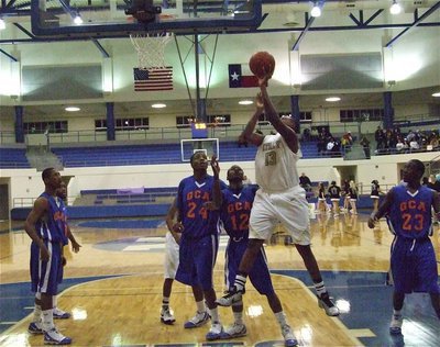 Image: Larry puts up a shot — Larry Mayberry(13) provided valuable minutes for the Gladiators as he battled Gateway’s 6’5" center Jimmy Sykes(24).