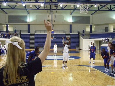 Image: Sierra signals — Italy High School cheerleader Sierra Harris holds up the #1 sign as Jasenio Anderson(11) swishes a free throw.
