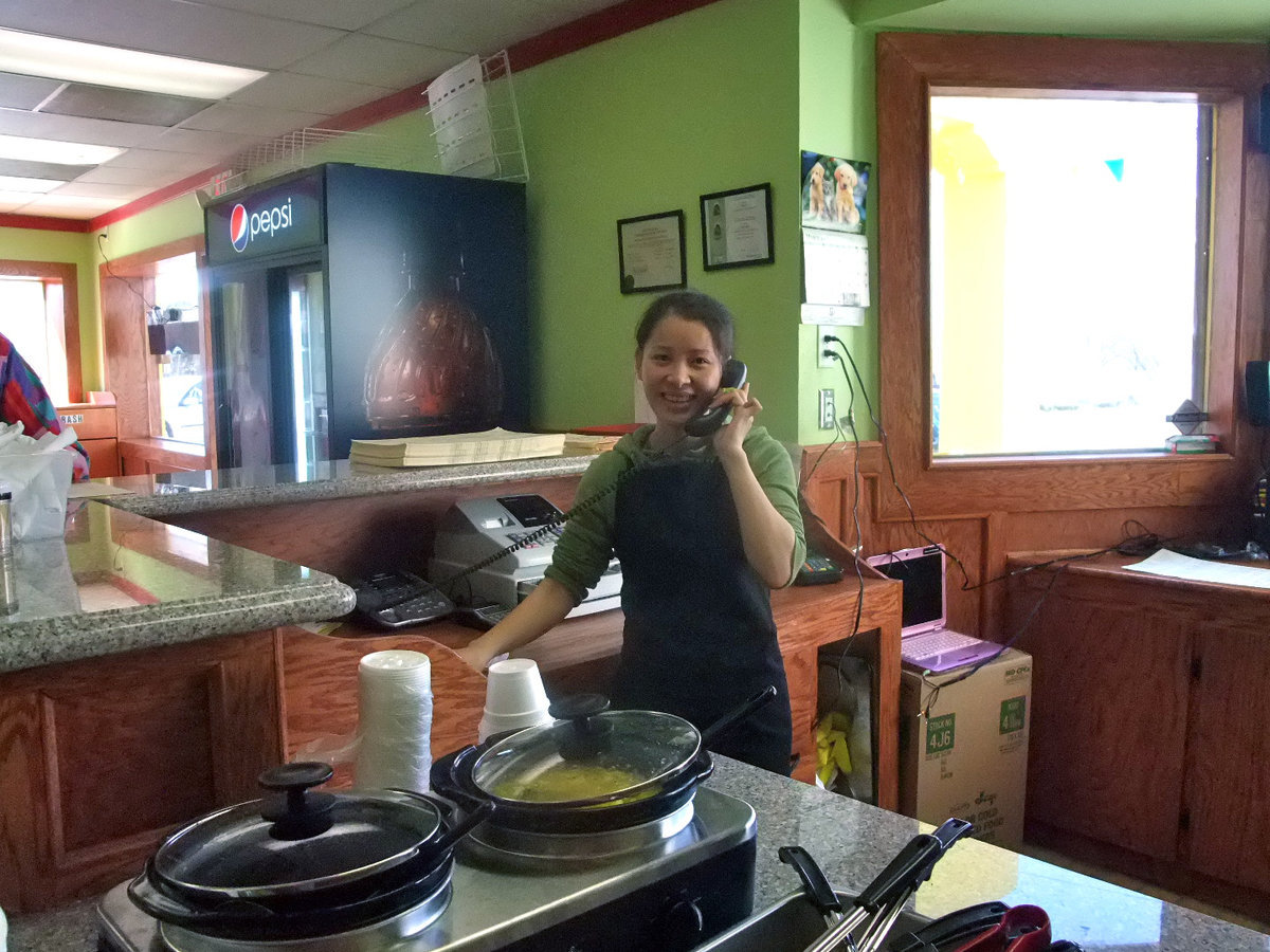 Image: Lim Mei Restaurant Manager — As busy as she was Lim Mei never lost her smile.