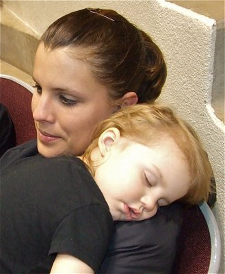 Image: Melissa &amp; May May — Melissa Souder holds her tuckered out baby girl, Mayson, before Italy’s 2nd game of the regional tournament.
