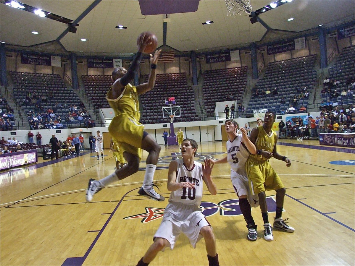 Image: Anderson climbs — Jasenio Anderson(11) takes it to the rim with authority for 2-points.