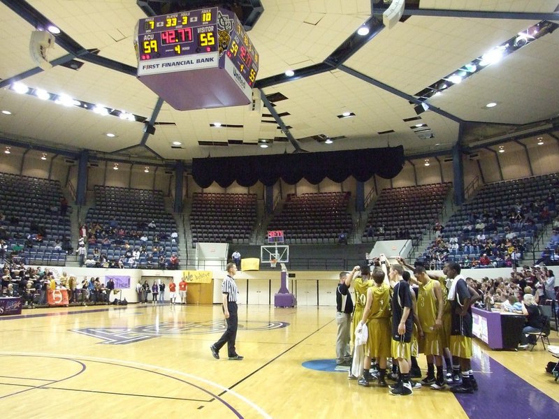 Image: Season ticking away — Trailing 59-55 with 42.77 left, the Gladiators huddle with their coaching staff to talk strategy.