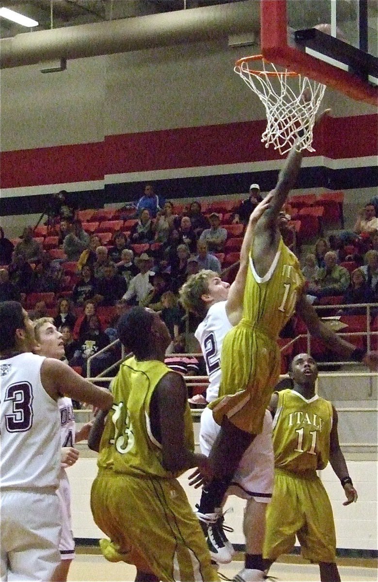 Image: John keeps jumping — Gladiator John Isaac(11) goes up for 2 more while being clawed by a Bearcat defender.