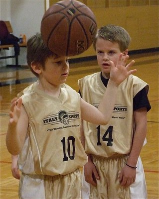 Image: No hands! — Rees Janek(14) seems to be impressed with Xander Galvan’s(10) balancing act.