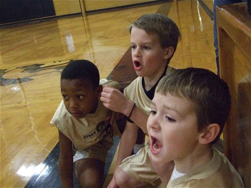 Image: Get the ball! — Zorian Burley, Reese Janek and Bryce DeBorde encourage their teammates before checking into the game.