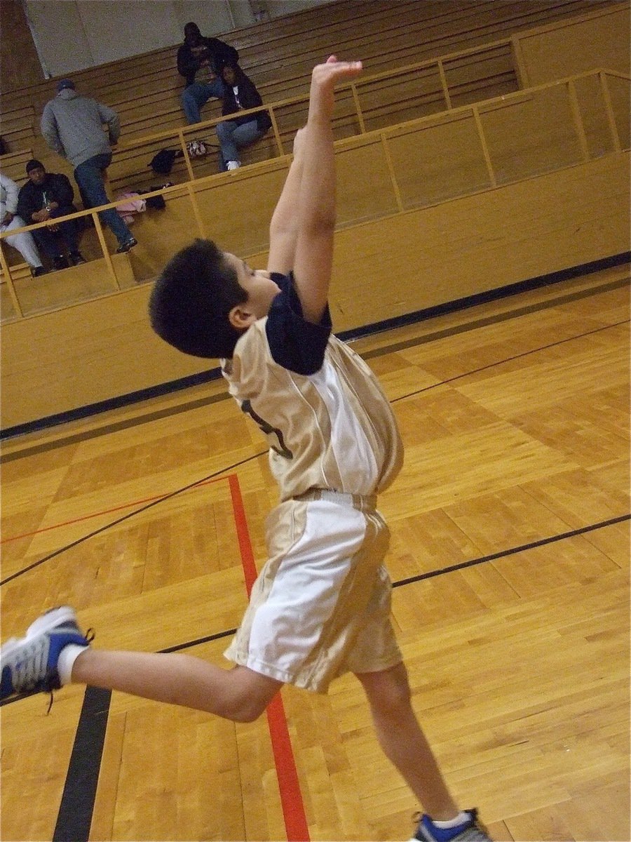 Image: Swan shot — Michael Gonzales(13) is poetry in motion from the free throw line.