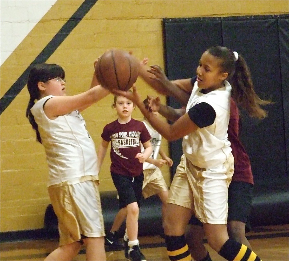 Image: Jenna and Emily — Jenna Holden(14) and Emily Cunningham(1) scrap fro the rebound against Hillsboro Maroon.