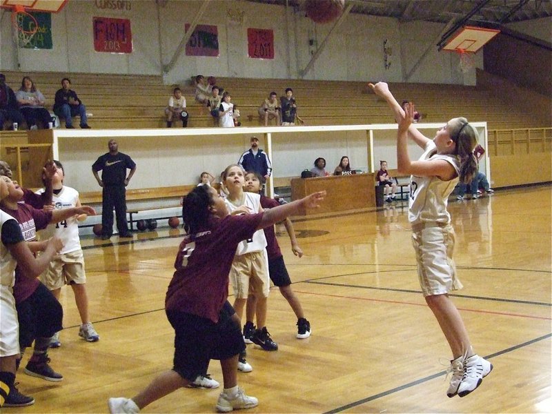 Image: Kirby shoots — Kirby Nelson(12) shoots over the Hillsboro Maroon defense while Paige Henderson(2), Jenna Holden(14) and Emily Cunningham(1) get in rebounding position.