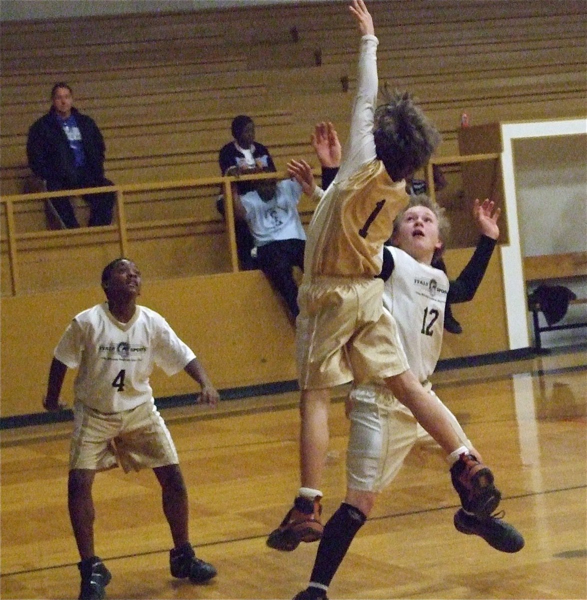 Image: Levi soars — Levi McBride(1) tries to score over Lance McClendon(12) as Markavion Thompson(4) gets ready to rebound.