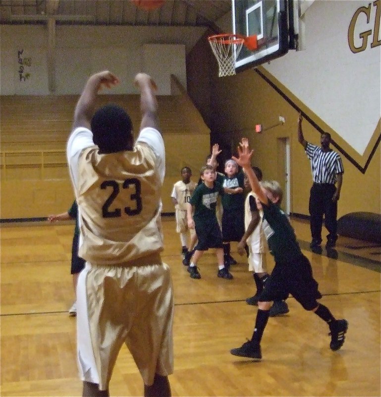 Image: Firing away — Kenneth Norwood(23) takes aim at a long-range jumper.