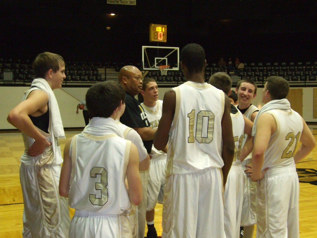 Image: Solid season — Head coach Larry Mayberry shares a light moment with his players after another amazing season by the J.V. Gladiators.