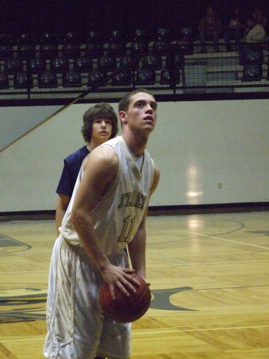 Image: Brandon sets to shoot — J.V. Gladiator Brandon Souder(11) takes his time at the line.