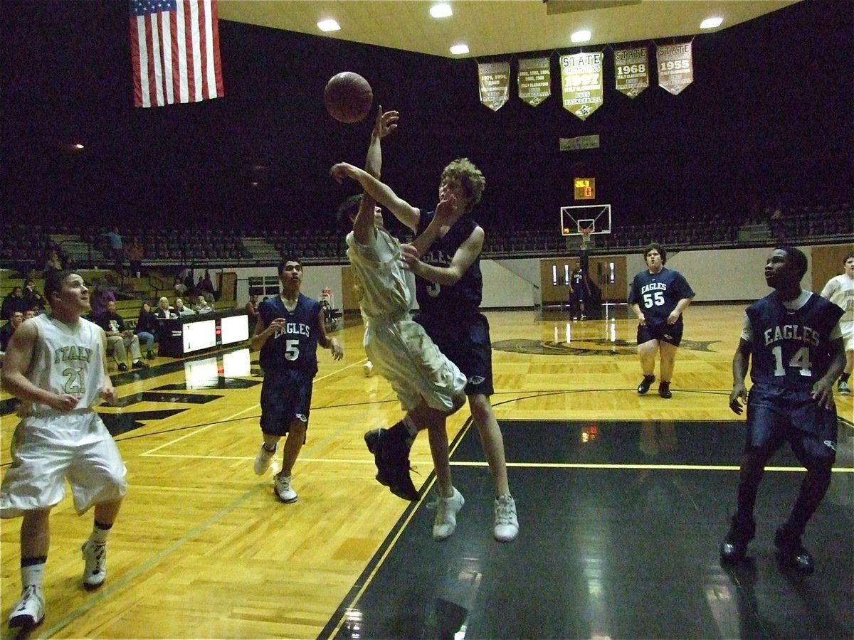 Image: Caden gets clobbered — Caden Jacinto(3) takes it hard to the rack and takes the hard foul.