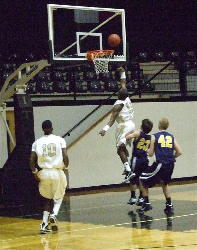 Image: Dez drives — Senior leader Desmond Anderson(15) steals and drives to the basket.