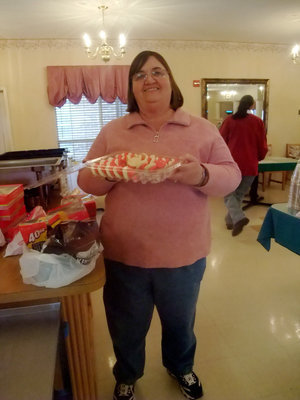 Image: Carolyn Powell and Cookies — Carolyn Powell (activities director) has come up with Valentine fun.