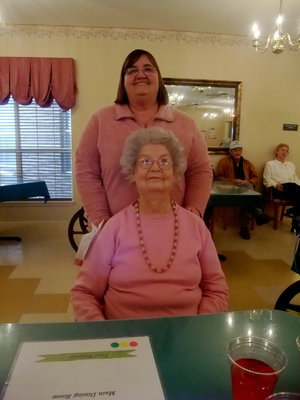 Image: Carolyn and Evelyn — Carolyn Powell (activities director) and Evelyn are dressed in red and pink for Valentines Day.