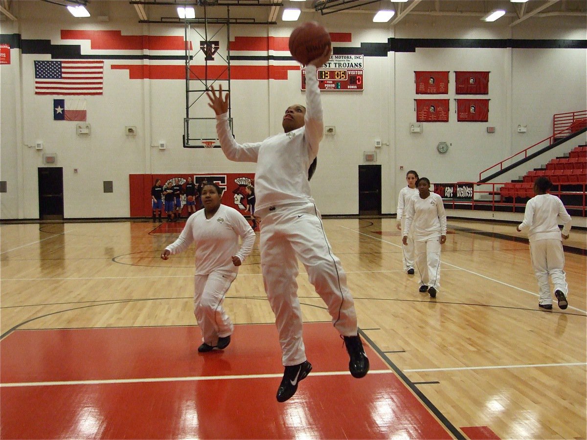 Image: Lady G’s get ready — Kyonne Birdsong, Khadijah Davis and their Lady Gladiator teammates get warmed up before the bi-district championship game against Bosqueville.