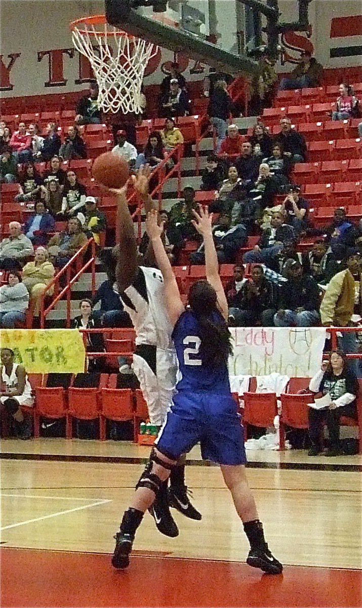 Image: Reed rises — Jimesha Reed(40) rises above the outstretched hands of a Lady Bulldog for 2-points.