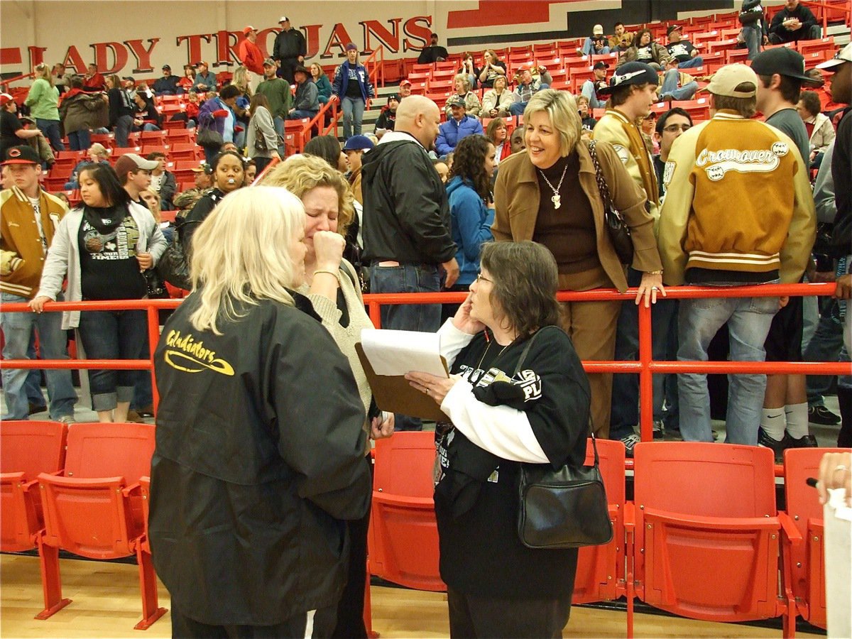 Image: Just let it out — Italy Lady Gladiator head coach Stacy McDonald can’t hold in her emotions after her team held on to win the bi-district championship over Bosqueville. Rita Garza and Karen Mathiowetz comfort coach McDonald while she takes a moment to let it out.