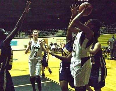 Image: Fleming powers — Jaleecia Fleming(32) powers her way up to the basket as Kaitlyn Rossa(3) gets ready to rebound.