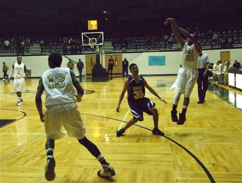 Image: Sure shot — De’Andre Sephus(20) launches the 3-pointer over an Eagle defender as Aaron Thomas(12) moves in for the rebound. Sephus finished with 15-points.