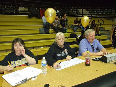 Image: Helping the kids — Karen Mathiowetz, Rita Garza and Greg Richards take care of the stats and clock during the games on “Parent Night.”