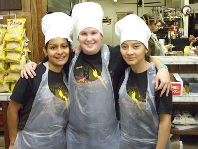 Image: Three little chefs — Laura Luna, Drenda Burk and Maria Luna work the dessert table at Oodles of Noodles Italy Band feast.